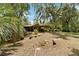 Exterior view of a house with a screened porch surrounded by trees at 6410 Amelia Ln, Dade City, FL 33523