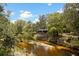 Quaint home perched above the river with beautiful surrounding trees and vegetation at 6410 Amelia Ln, Dade City, FL 33523
