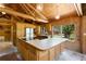 Charming kitchen features wood cabinetry, stainless steel appliances, a large island, and plenty of natural light at 6410 Amelia Ln, Dade City, FL 33523