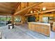 Open kitchen with wood paneling, stainless appliances, large island and natural light is a focal point for gatherings at 6410 Amelia Ln, Dade City, FL 33523