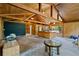 Rustic kitchen features wood-paneled walls, a large island, and stainless steel appliances, offering a cozy atmosphere at 6410 Amelia Ln, Dade City, FL 33523