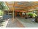 Outdoor space with a covered patio, grill area, and lush greenery at 6410 Amelia Ln, Dade City, FL 33523