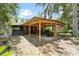 Outdoor space featuring a covered patio, grill area, and lush greenery at 6410 Amelia Ln, Dade City, FL 33523