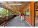 Covered patio with outdoor kitchen featuring a built-in grill and refrigerator at 6410 Amelia Ln, Dade City, FL 33523