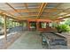 Covered patio with outdoor kitchen featuring a built-in grill at 6410 Amelia Ln, Dade City, FL 33523