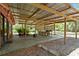 Covered patio with outdoor kitchen featuring a built-in grill at 6410 Amelia Ln, Dade City, FL 33523