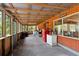 Large screened porch with wood ceiling, wood walls, and windows looking out to the yard at 6410 Amelia Ln, Dade City, FL 33523