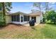 Back exterior of home featuring a screened patio and sliding glass doors at 6509 Pine Meadows Dr, Spring Hill, FL 34606