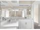 Bathroom with dual sinks, white cabinets and white stone countertops at 6509 Pine Meadows Dr, Spring Hill, FL 34606