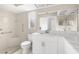 Bathroom with a white sink, toilet, and tile shower with convenient accessibility features at 6509 Pine Meadows Dr, Spring Hill, FL 34606