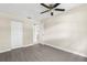 Spacious bedroom with luxury vinyl plank flooring, ceiling fan, and double door closet at 6509 Pine Meadows Dr, Spring Hill, FL 34606
