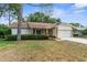 Charming single-story home with manicured landscaping, stone accents and a two-car garage at 6509 Pine Meadows Dr, Spring Hill, FL 34606