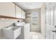 Laundry room equipped with a utility sink, shelving, and washer/dryer at 6509 Pine Meadows Dr, Spring Hill, FL 34606