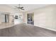 Open-concept living room with sliding glass doors to lanai and breakfast bar overlooking the kitchen at 6509 Pine Meadows Dr, Spring Hill, FL 34606