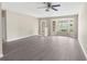 Spacious living room featuring luxury vinyl plank flooring, large windows and a decorative front door at 6509 Pine Meadows Dr, Spring Hill, FL 34606