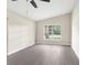 Bright living room with vaulted ceiling, gray wood-look floors, and a large picture window at 6509 Pine Meadows Dr, Spring Hill, FL 34606