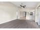 Open-concept living room featuring a ceiling fan and sliding glass doors with access to the outdoors at 6509 Pine Meadows Dr, Spring Hill, FL 34606