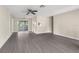 Open living room featuring modern gray floors, light walls and ample space at 6509 Pine Meadows Dr, Spring Hill, FL 34606