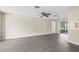Spacious living room showcasing sleek gray floors and abundant natural light at 6509 Pine Meadows Dr, Spring Hill, FL 34606