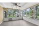Enclosed sun room offering an airy feel with abundant windows and modern flooring at 6509 Pine Meadows Dr, Spring Hill, FL 34606