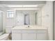 Bright bathroom with white vanity, large mirror, and toilet at 6545 North Lake Dr, Zephyrhills, FL 33542