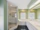 Spacious primary bathroom with a glass shower, soaking tub, and double vanity at 6545 North Lake Dr, Zephyrhills, FL 33542