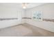 This bedroom has neutral carpet, a ceiling fan, and natural light from the window at 6545 North Lake Dr, Zephyrhills, FL 33542