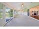 Large sunroom with lots of windows, carpeted floors and open access to the Living Room at 6545 North Lake Dr, Zephyrhills, FL 33542