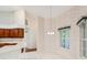 Dining room area adjacent to kitchen features a large window and classic finishes at 6545 North Lake Dr, Zephyrhills, FL 33542
