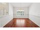Bright dining room featuring hardwood floors, a large window, and an elegant chandelier at 6545 North Lake Dr, Zephyrhills, FL 33542