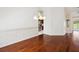 A dining room features wood floors and access to the kitchen and an adjacent room at 6545 North Lake Dr, Zephyrhills, FL 33542