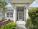 Welcoming home entrance with stately columns and lush landscaping at 6545 North Lake Dr, Zephyrhills, FL 33542