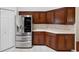 Kitchen with stainless steel refrigerator, white countertops, and dark wood cabinets at 6545 North Lake Dr, Zephyrhills, FL 33542