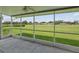 Relaxing screened-in lanai with views of the lush green lawn at 6545 North Lake Dr, Zephyrhills, FL 33542