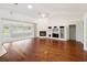 Open-concept living room featuring a fireplace, built-ins, and access to a sunroom at 6545 North Lake Dr, Zephyrhills, FL 33542