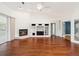 Spacious living room with hardwood floors, fireplace, and views into other areas of home at 6545 North Lake Dr, Zephyrhills, FL 33542