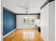 Sunlit office with hardwood floors, a ceiling fan, and a built in desk with cabinets at 6545 North Lake Dr, Zephyrhills, FL 33542