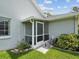 Side entrance to home including a screened entry and landscaped yard at 6545 North Lake Dr, Zephyrhills, FL 33542