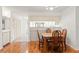 Cozy dining area with wood floors, seating for four, and a pass-through to the kitchen at 6590 Brambleleaf Dr, Spring Hill, FL 34606