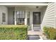Inviting front entrance with bay window, decorative door and trimmed shrubbery at 6590 Brambleleaf Dr, Spring Hill, FL 34606