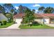 Charming single-story home with attached garage and landscaped front yard under a bright, blue sky at 6590 Brambleleaf Dr, Spring Hill, FL 34606