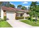 Well-maintained home with stone accents, manicured bushes, and a neatly paved driveway at 6590 Brambleleaf Dr, Spring Hill, FL 34606