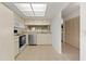 Bright kitchen featuring white appliances, tile floors, and ample cabinet space at 6590 Brambleleaf Dr, Spring Hill, FL 34606
