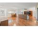 Bright living room featuring wood floors, a dining area, and a cozy entertainment center at 6590 Brambleleaf Dr, Spring Hill, FL 34606