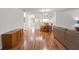 Open floor plan with hardwood floors connecting living, dining, and kitchen areas at 6590 Brambleleaf Dr, Spring Hill, FL 34606