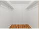 Empty walk-in closet with built-in shelving and wood-look floors at 6590 Brambleleaf Dr, Spring Hill, FL 34606