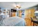 Spacious bedroom with wood floors, closet space, and a TV for comfortable living at 7118 Cherry Laurel Dr, Port Richey, FL 34668