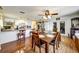 Inviting dining area seamlessly connected to the kitchen with wood flooring and a modern ceiling fan at 7118 Cherry Laurel Dr, Port Richey, FL 34668