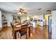 Open dining area featuring wood floors and a breakfast bar with seating leading into the kitchen at 7118 Cherry Laurel Dr, Port Richey, FL 34668