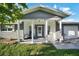 Inviting front porch with seating, featuring brick accents and white columns at 7118 Cherry Laurel Dr, Port Richey, FL 34668